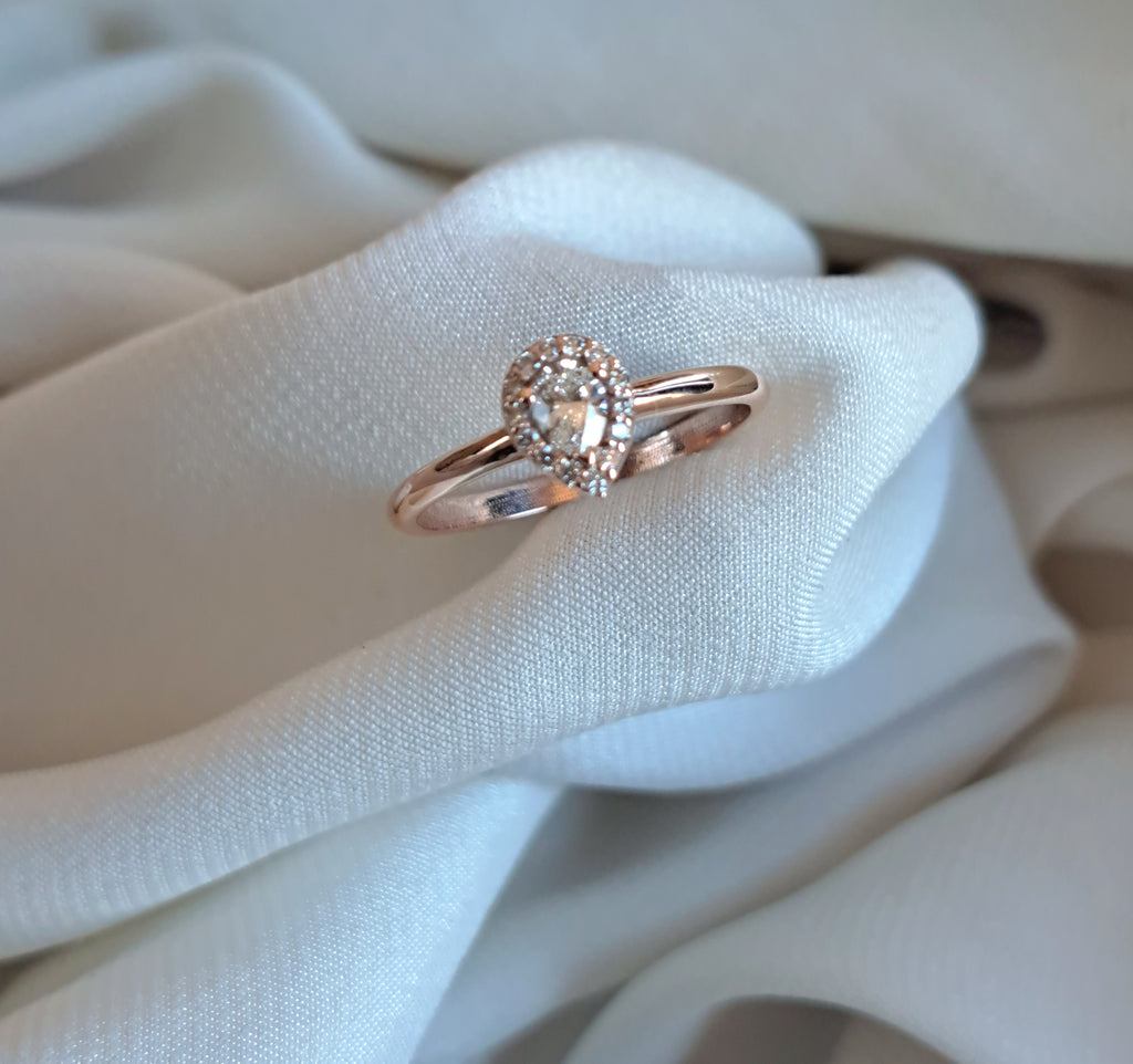 Pearshape moissanite with halo band.