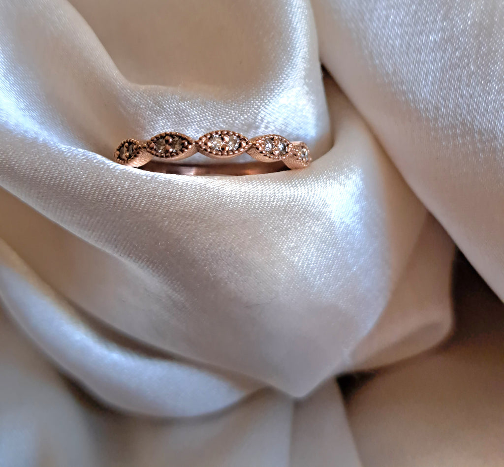 1.3mm round diamond scollop half eternity band.