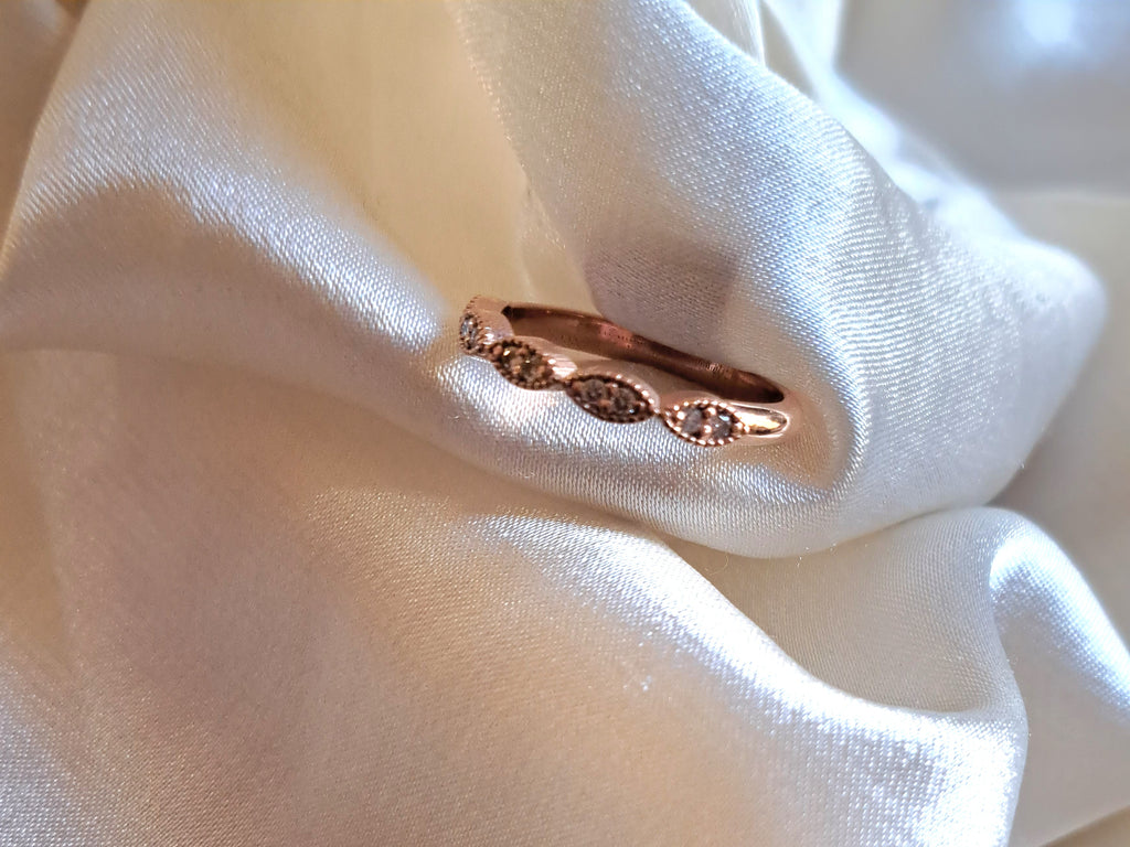 1.3mm round diamond scollop half eternity band.