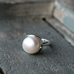 Pearl in silver concave cup ring