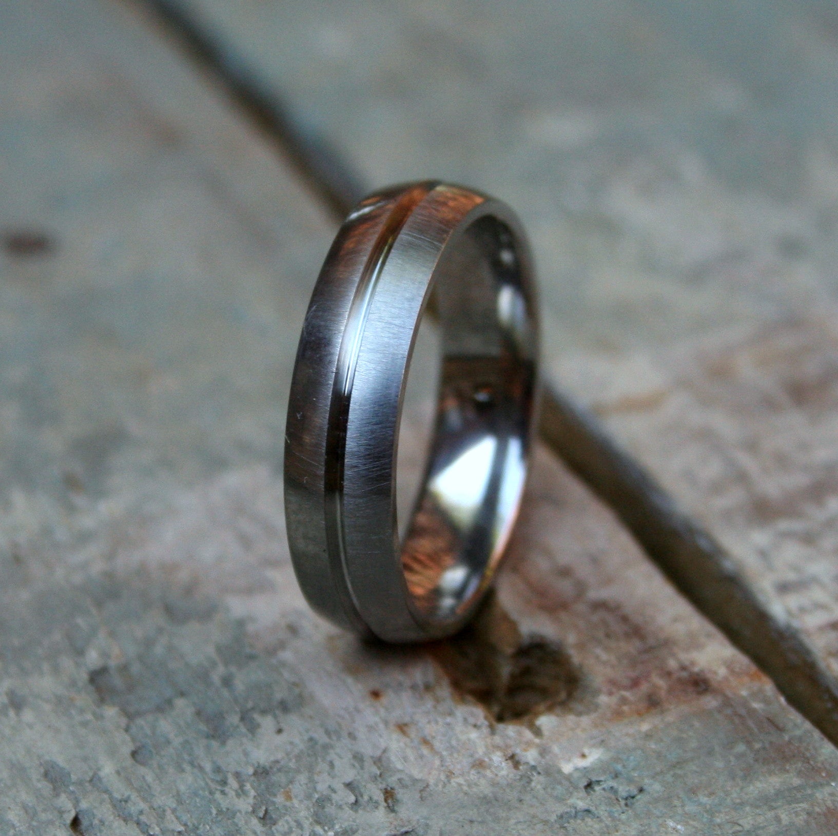 6mm Titanium D shape band with a groove cut into the metal. The ring is made with a brushed finish and a comfort fit on the inside. The groove has a polished finish.