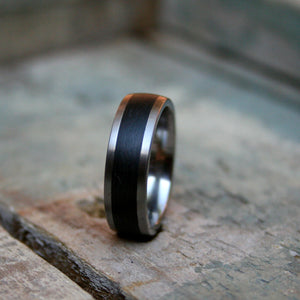 6mm  D shape Titanium band with a 4 mm carbon fibre inlay.  The ring is made with a comfort fit on the inside.