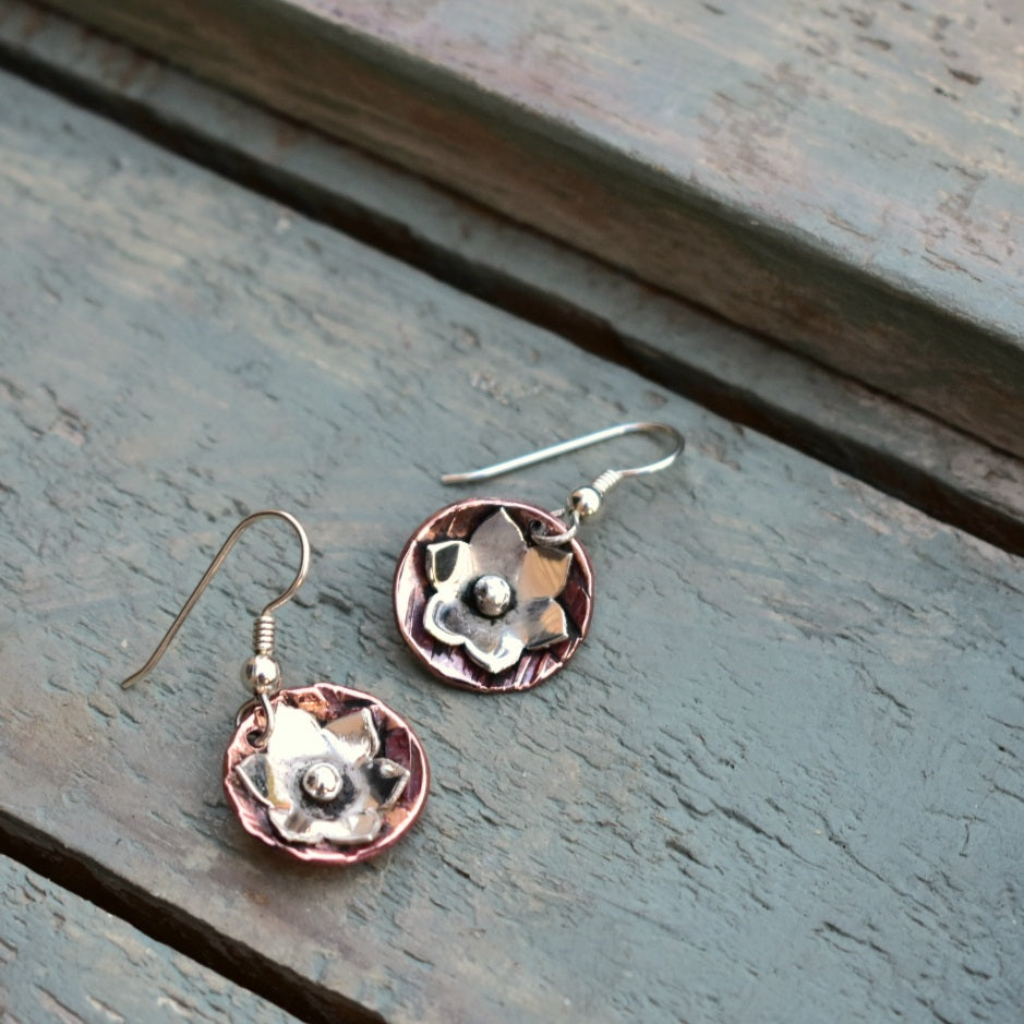 Silver daisy on copper dome disc dangle earrings