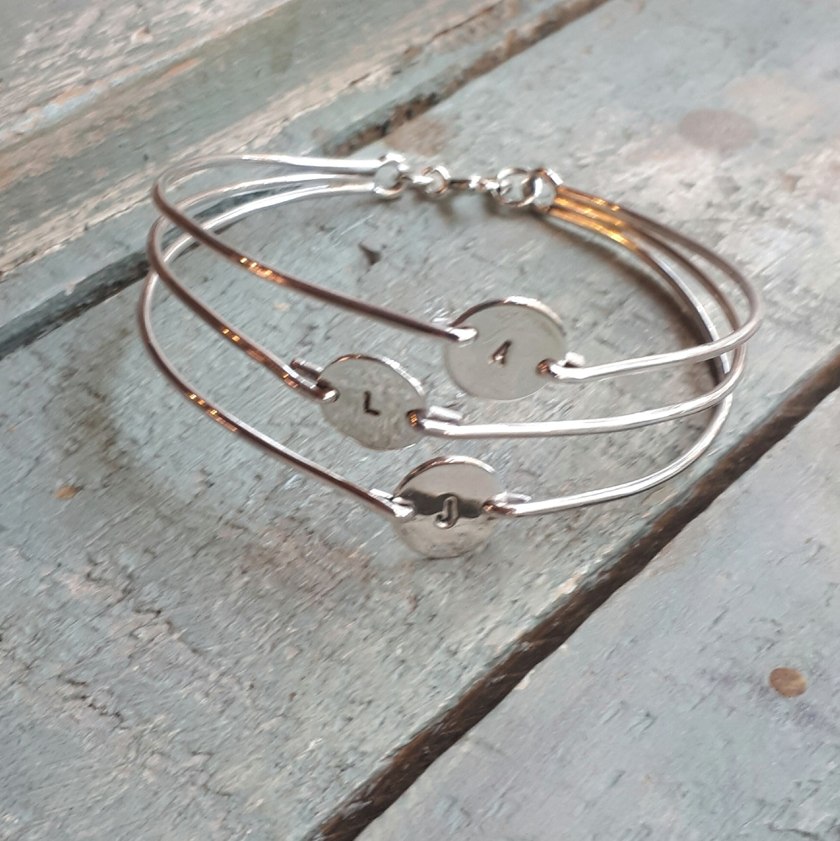 A sterling silver bangle with three 10 mm discs on 1.5mm wire.