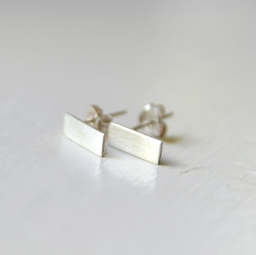 Sterling silver flat bar studs, 12mm long with a matt or polished finish.  Please note all pieces are made on order by Erfdeel Juwele. Allow up to one week for manufacture.
