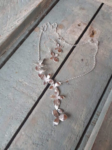 Silver necklace with a neck piece consisting of 7 orchid flowers. Total length of chain is 45cm.

Please note all pieces are made on order by Erfdeel Juwele. Allow up to two weeks for manufacture when placing an order.


