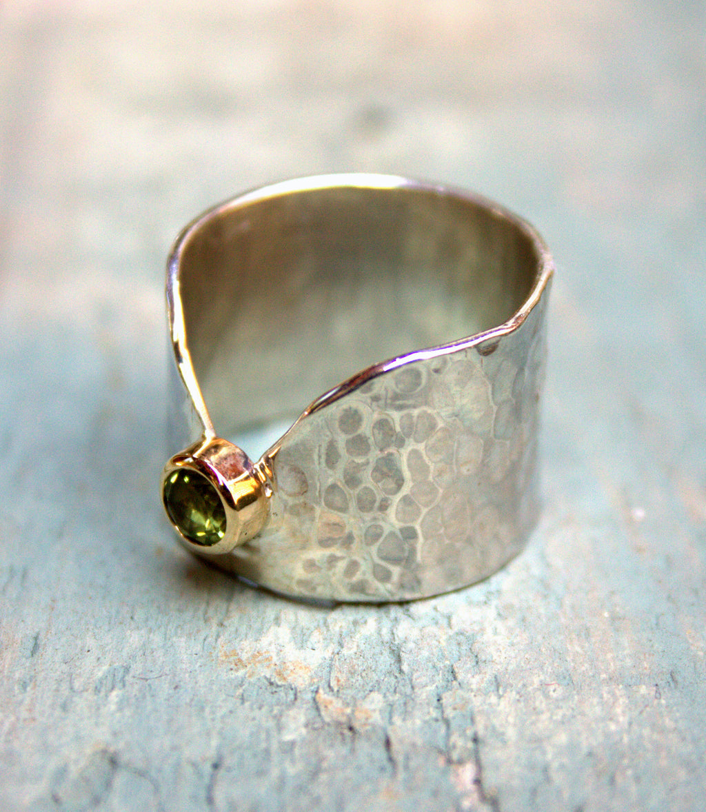 Silver band with peridot set in yellow gold