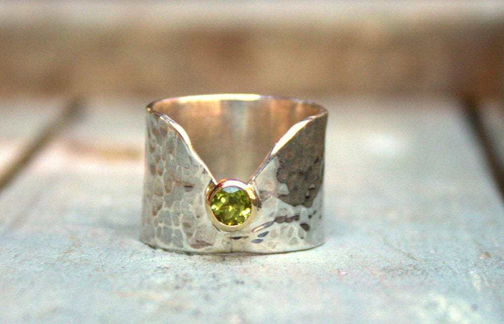 Silver band with peridot set in yellow gold