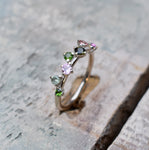 9ct White gold band set with 7 tourmaline stones of various pink and green colour variations. 2 2mm, 3 2.5mm and 2 3mm stones.  Please note all pieces are made on order by Erfdeel Juwele. Allow up to 2 weeks for manufacture.