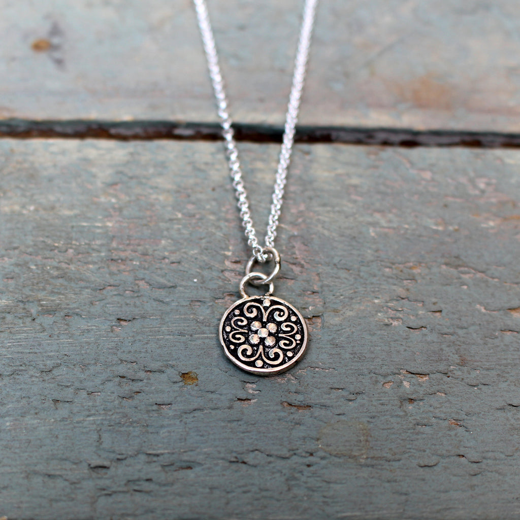 Vintage patterned disc pendant in oxydised sterling silver.